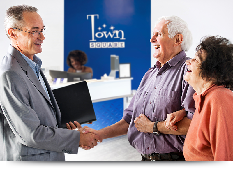 1 / 1 – Worker-welcoming-elderly-couple_Accent_H_800x580.png