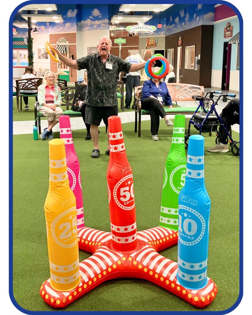 o	Senior man enjoying an interactive ring toss game at Town Square NW Austin, highlighting activities that promote socialization and mental stimulation to help manage seasonal depression and support dementia care in Austin, Texas.